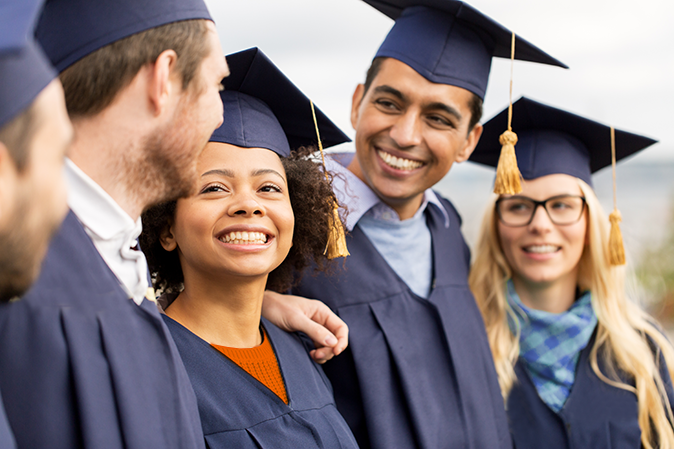Group of smiling graduates outside